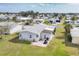 Aerial shot of a home with a well-maintained lawn, patio area, and surrounding neighborhood at 8436 Buttonquail Dr, Englewood, FL 34224