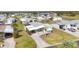 This aerial shot highlights the home and its surrounding community with tree-lined streets and well-kept lawns at 8436 Buttonquail Dr, Englewood, FL 34224