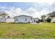 Home with a spacious backyard, a patio, and well-maintained lawn at 8436 Buttonquail Dr, Englewood, FL 34224