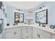 Modern bathroom featuring dual sinks, ample counter space, and stylish light fixtures at 8436 Buttonquail Dr, Englewood, FL 34224