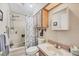 Traditional bathroom featuring a shower-tub combo and single sink vanity with overhead storage at 8436 Buttonquail Dr, Englewood, FL 34224