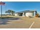 Exterior shot of the Lakeside Club with a parking lot and flag at 8436 Buttonquail Dr, Englewood, FL 34224