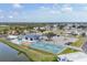 Aerial shot highlighting community amenities: clubhouse, pool, and pickleball courts at 8436 Buttonquail Dr, Englewood, FL 34224