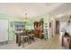 Dining room featuring a table with seating for four, a china cabinet and natural light at 8436 Buttonquail Dr, Englewood, FL 34224