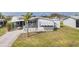 Inviting single-story home featuring a covered carport and well-manicured lawn at 8436 Buttonquail Dr, Englewood, FL 34224