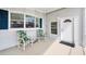 Charming front porch featuring two chairs, a small table, and a 'Welcome' sign at 8436 Buttonquail Dr, Englewood, FL 34224