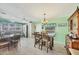 Eat-in kitchen featuring stainless steel appliances, a breakfast bar, and a dining table with chairs at 8436 Buttonquail Dr, Englewood, FL 34224