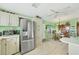 Open kitchen with a large stainless-steel refrigerator, breakfast nook, and white cabinets at 8436 Buttonquail Dr, Englewood, FL 34224