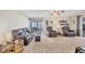 Open living room featuring plush carpeting, a large sofa, two recliners, and sliding glass doors at 8436 Buttonquail Dr, Englewood, FL 34224