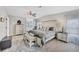 Spacious bedroom with wood-look floors, large bed, windows, and a walk-in closet at 8436 Buttonquail Dr, Englewood, FL 34224