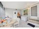 Enclosed and covered porch with windows and a white exterior door and plenty of storage at 8436 Buttonquail Dr, Englewood, FL 34224