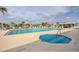Large in-ground pool with many chairs and a hot tub at 8436 Buttonquail Dr, Englewood, FL 34224