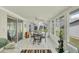 Bright sunroom with tile flooring, a ceiling fan, and large windows offering ample natural light at 8436 Buttonquail Dr, Englewood, FL 34224