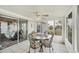 Sunroom with tile flooring, a ceiling fan, and large windows that let in plenty of sunlight at 8436 Buttonquail Dr, Englewood, FL 34224