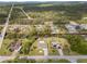 Aerial view of a residential neighborhood with homes along a canal, surrounded by lush greenery and trees at 975 Clearview Dr, Port Charlotte, FL 33953