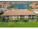 Aerial image shows a condo with screened balconies and lush landscaping near a tranquil waterfront community at 10063 Crooked Creek Dr # 103, Venice, FL 34293