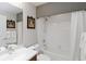 Well-maintained bathroom features a shower and tub combo, updated fixtures, and classic decor at 10508 Crooked Creek Dr, Venice, FL 34293