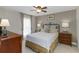 Comfortable bedroom showcasing a decorative iron bed frame, neutral tones, and ample natural light at 10508 Crooked Creek Dr, Venice, FL 34293