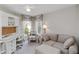 Cozy bedroom featuring a workspace with desk, cushioned chair and sofa, and natural light at 10508 Crooked Creek Dr, Venice, FL 34293