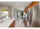 Breakfast nook view by stainless steel refrigerator overlooking pool at 10508 Crooked Creek Dr, Venice, FL 34293