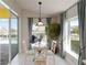 Breakfast nook features a glass table, chairs, and sliding glass doors with pool view at 10508 Crooked Creek Dr, Venice, FL 34293
