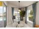 Breakfast nook view featuring a glass table, chairs, and natural light from pool view at 10508 Crooked Creek Dr, Venice, FL 34293