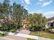 Charming home with a brick driveway, a two-car garage, and mature landscaping at 10508 Crooked Creek Dr, Venice, FL 34293