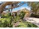 Charming home with a terracotta roof, well-manicured landscaping, and a brick driveway at 10508 Crooked Creek Dr, Venice, FL 34293