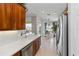 Kitchen view with stainless steel fridge, breakfast nook, and tile flooring at 10508 Crooked Creek Dr, Venice, FL 34293
