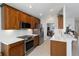 Kitchen boasts wooden cabinets, stainless steel appliances, and tile backsplash at 10508 Crooked Creek Dr, Venice, FL 34293