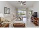 Inviting living room features tile floors, a ceiling fan, and a sliding glass door leading to the patio at 10508 Crooked Creek Dr, Venice, FL 34293