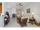 Open-concept living room with tile floors, ceiling fan, and comfortable seating arrangements at 10508 Crooked Creek Dr, Venice, FL 34293