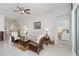 Bright living room featuring tile floors, a ceiling fan, and comfortable seating arrangements at 10508 Crooked Creek Dr, Venice, FL 34293