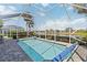 A refreshing in-ground pool is surrounded by a screened enclosure, offering clear lake views at 10508 Crooked Creek Dr, Venice, FL 34293