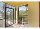 View of the sunroom with brick flooring, a white bench, and screened windows offering natural light at 10508 Crooked Creek Dr, Venice, FL 34293