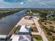Gorgeous aerial view of an oversized lot with a waterfront property including a canal, screened-in patio, and a pristine lawn at 10688 Mcalester Cir, Port Charlotte, FL 33981