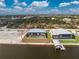 Aerial view of the property showing the screened-in pool and canal access at 10688 Mcalester Cir, Port Charlotte, FL 33981