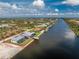 Aerial view of the property and neighborhood highlighting canal access at 10688 Mcalester Cir, Port Charlotte, FL 33981