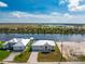 Waterfront home featuring modern design, landscaping, brick paver driveway and canal access at 10688 Mcalester Cir, Port Charlotte, FL 33981