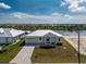 Beautiful new home with modern design, landscaping, and a brick paver driveway at 10688 Mcalester Cir, Port Charlotte, FL 33981