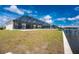 Back of the house with large screened-in patio and canal with dock and boat lift at 10688 Mcalester Cir, Port Charlotte, FL 33981