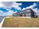 Large screened-in patio with view of backyard, canal, and boat lift at 10688 Mcalester Cir, Port Charlotte, FL 33981
