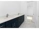 Modern bathroom featuring double sink vanity with dark blue cabinetry and modern hardware at 10688 Mcalester Cir, Port Charlotte, FL 33981