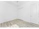 Bedroom boasts wood-look floors, white walls, closet and a ceiling fan at 10688 Mcalester Cir, Port Charlotte, FL 33981
