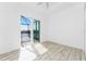 Bedroom features sliding doors that lead to a patio and lake view at 10688 Mcalester Cir, Port Charlotte, FL 33981