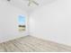 Bright bedroom showcasing a ceiling fan, ample natural light, and neutral flooring at 10688 Mcalester Cir, Port Charlotte, FL 33981