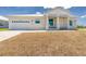 Beautiful single-story home with a white metal roof, a garage, and xeriscaping at 10688 Mcalester Cir, Port Charlotte, FL 33981