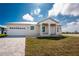 Charming single-story home boasting a clean facade, attached two-car garage, and neatly paved driveway at 10688 Mcalester Cir, Port Charlotte, FL 33981