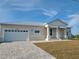 Charming single-story home with a metal roof, a two-car garage, and a well-manicured front yard at 10688 Mcalester Cir, Port Charlotte, FL 33981