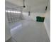 Spacious two car garage with epoxy flooring, an automatic door, and ample storage at 10688 Mcalester Cir, Port Charlotte, FL 33981